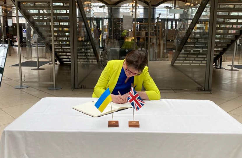 Selaine Saxby MP signing the book of solidarity 